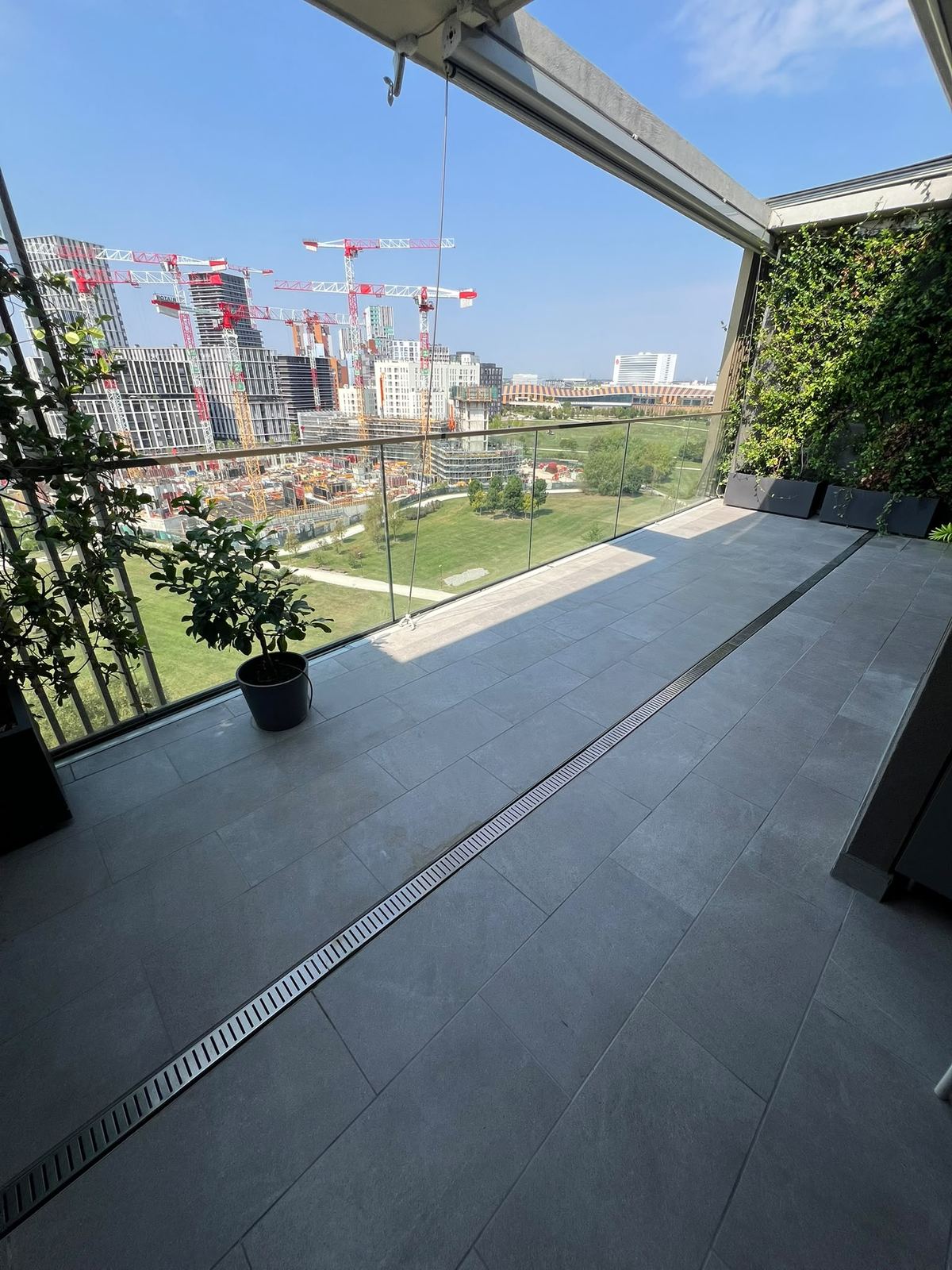 Terrazzo a Milano ultimato con pavimento in gres e canalina di scolo a vista